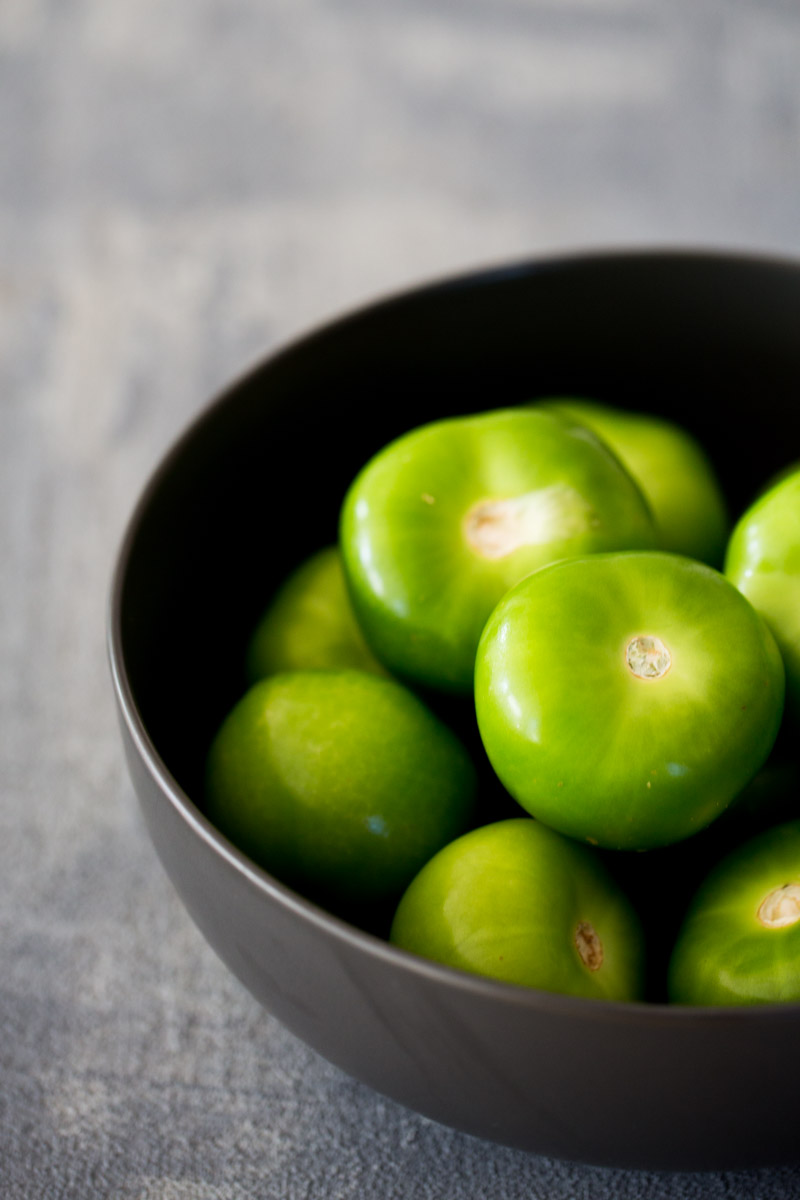 Tomatillos in a bowl to make mexican salsa verde