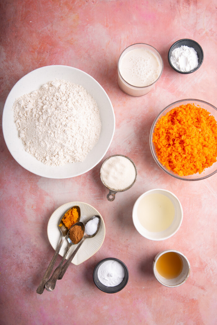 flour and other ingredients in bowls to make carrot cake