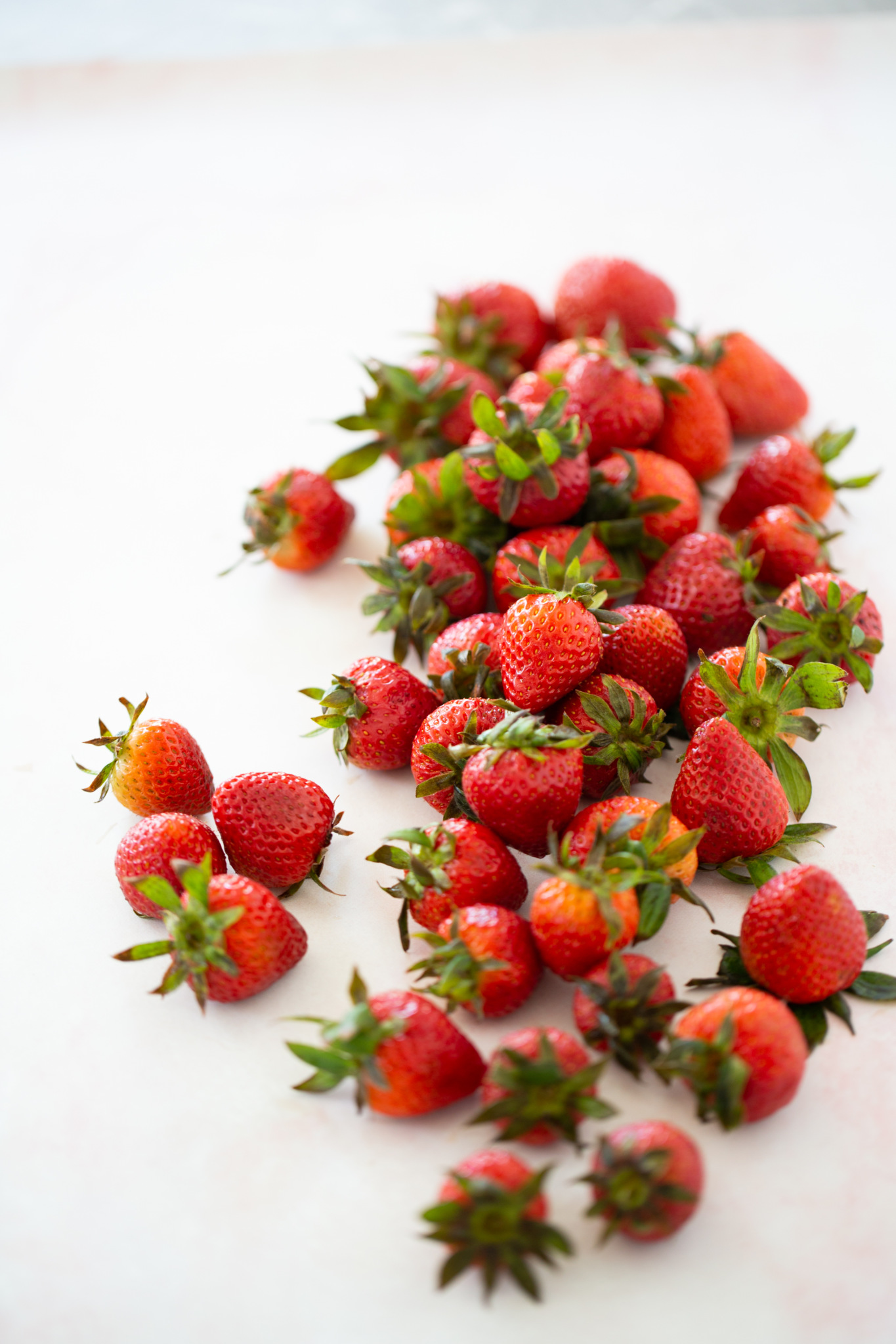 strawberries on a white surface
