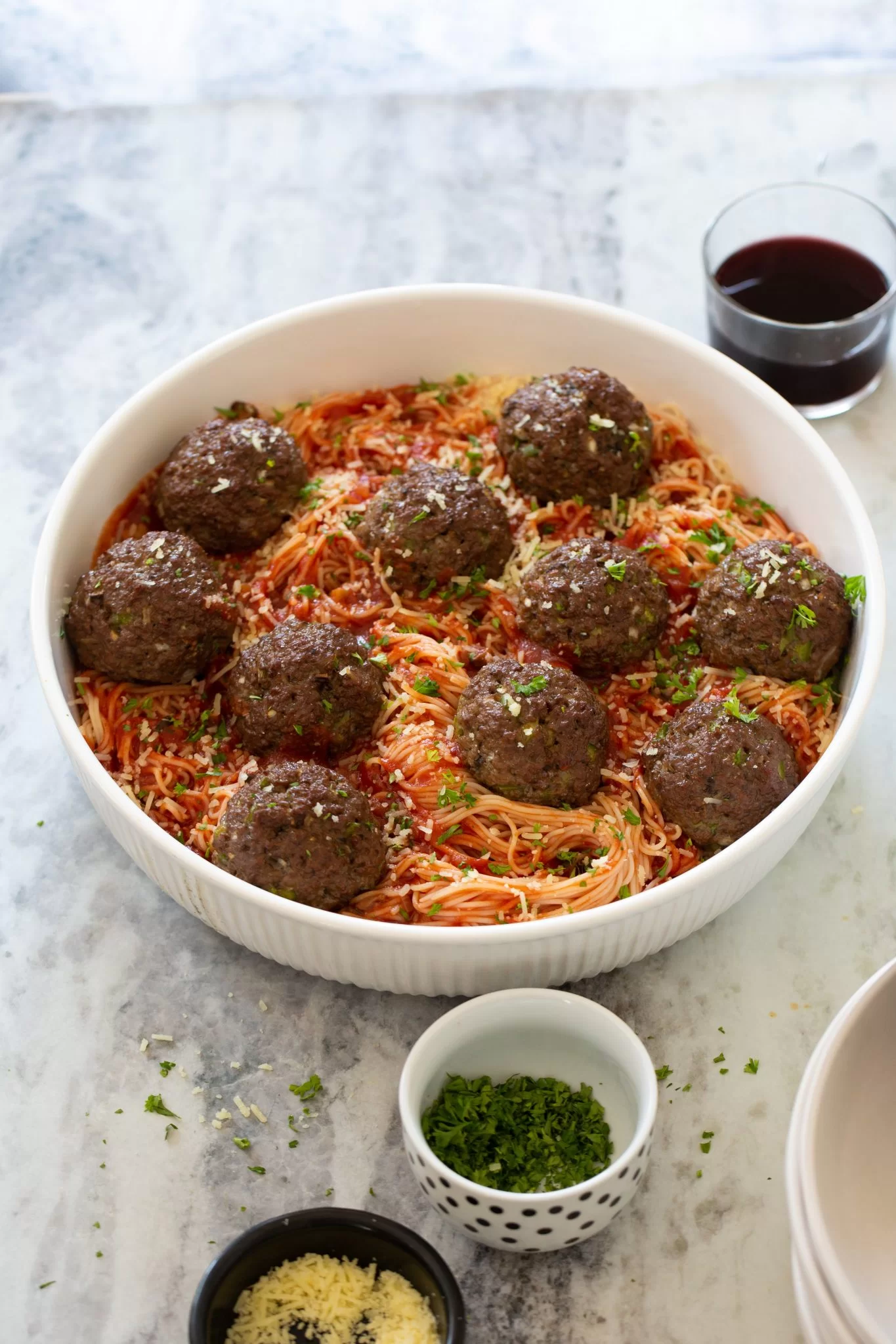 EASY SPAGHETTI AND MEATBALLS: Meatballs and spaghetti in a white bowl.