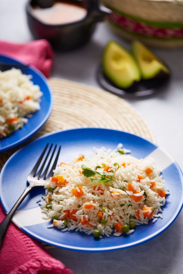 Mexican white rice on a blue and white dish.