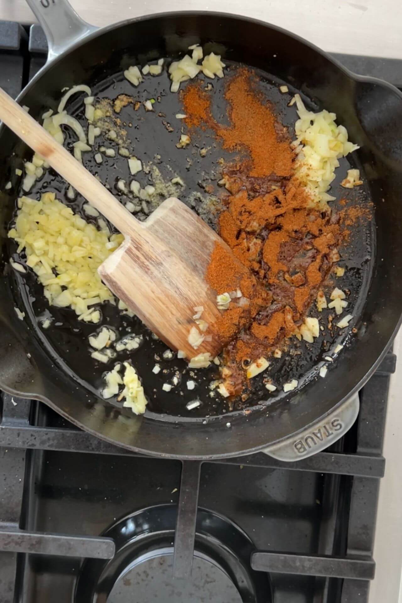 Sauteeing onion and spices in a cast iron pan