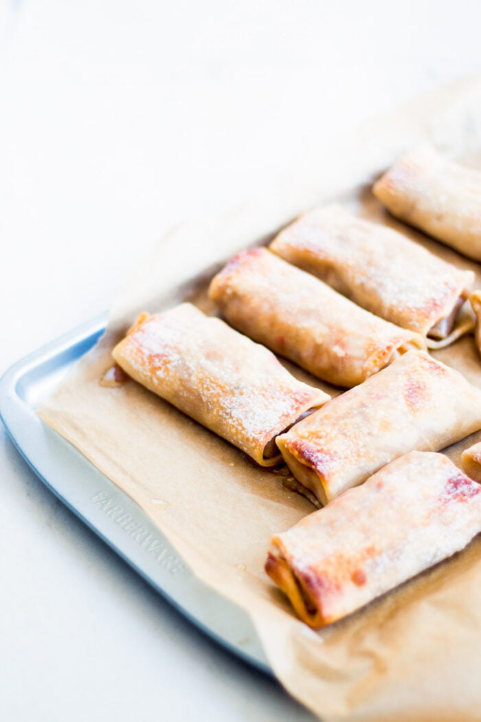 baking sheet with baked egg rolls.