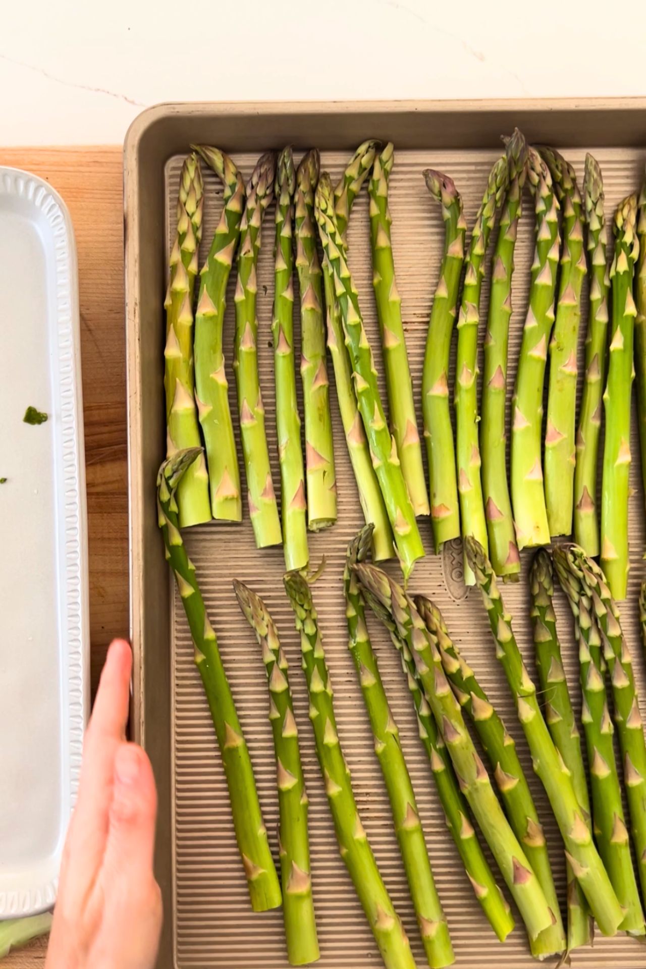 baking sheet with clean asparagus spears with the bottom removed