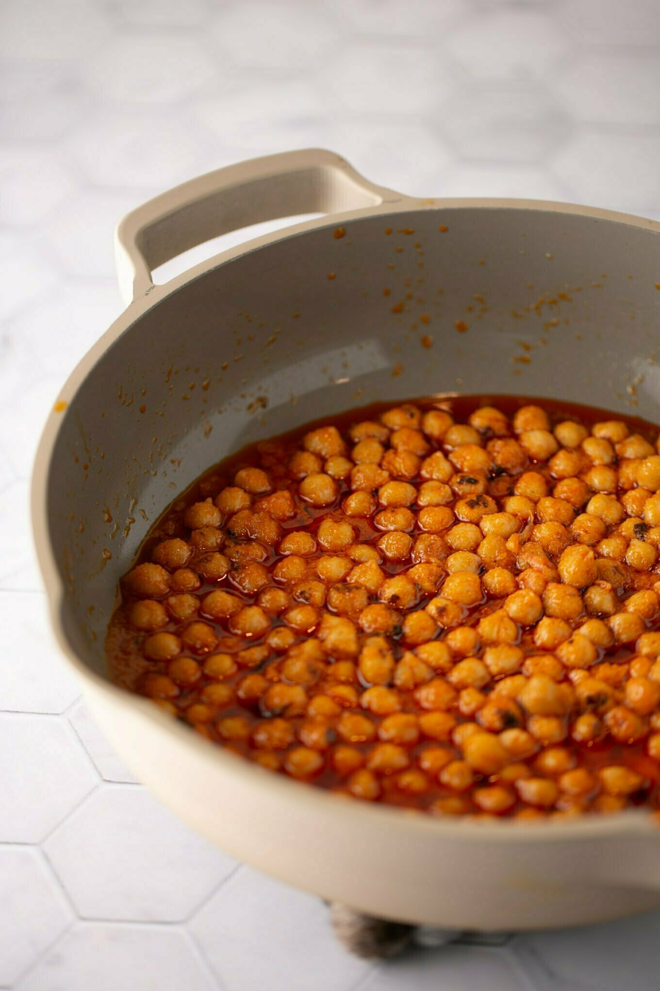 chickpeas in a pan with buffalo sauce