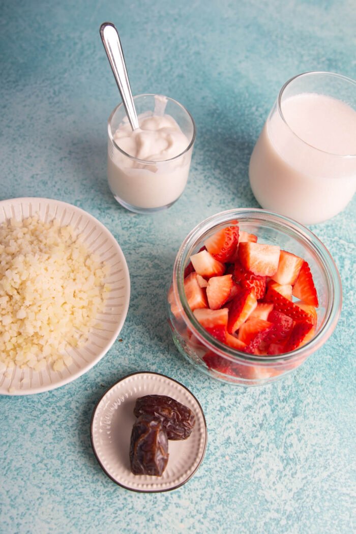 jar with strawberries, yogurt, almond milk and grated cauliflower