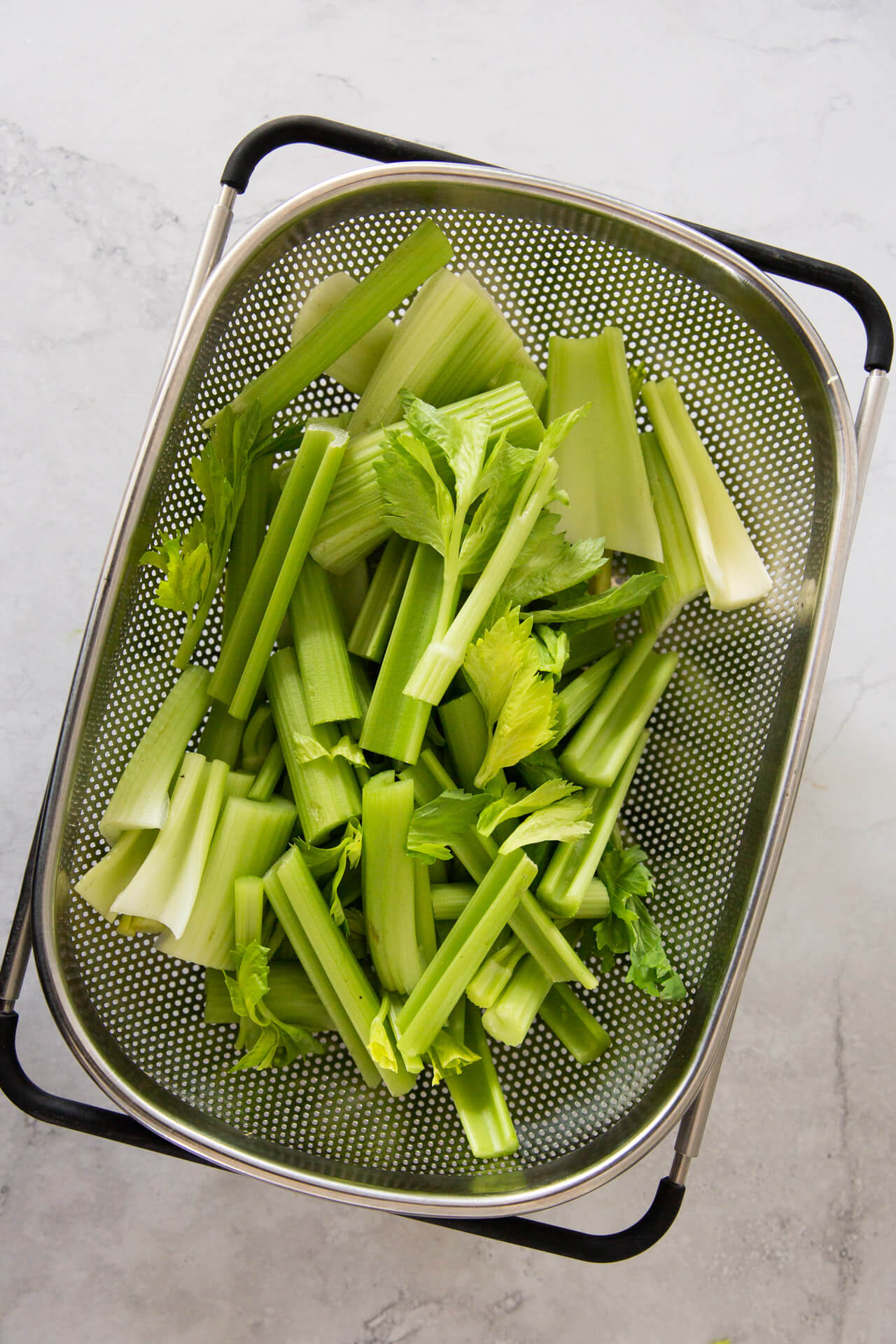 celery washed in a rectangular strainer