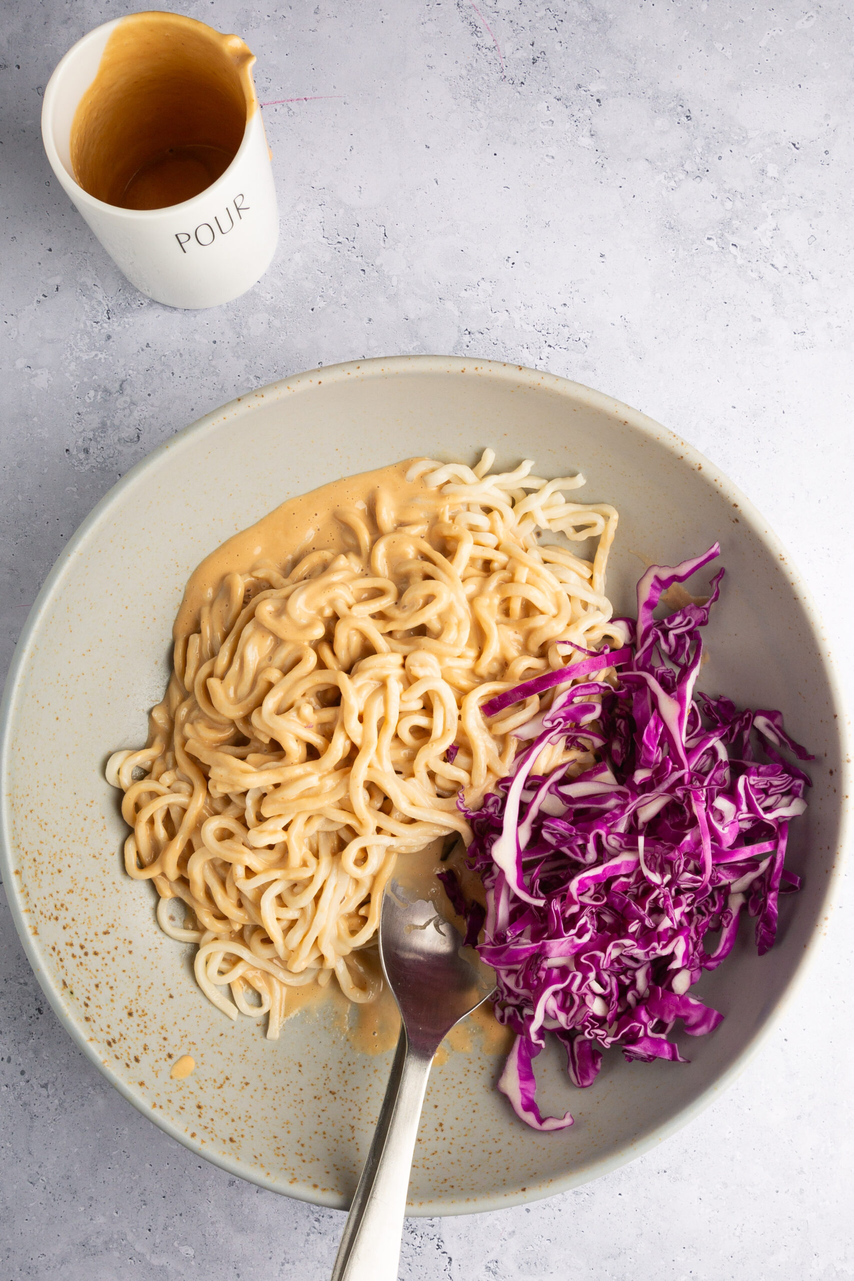 large bowl with noodles, with creamy dressing and red cabagge