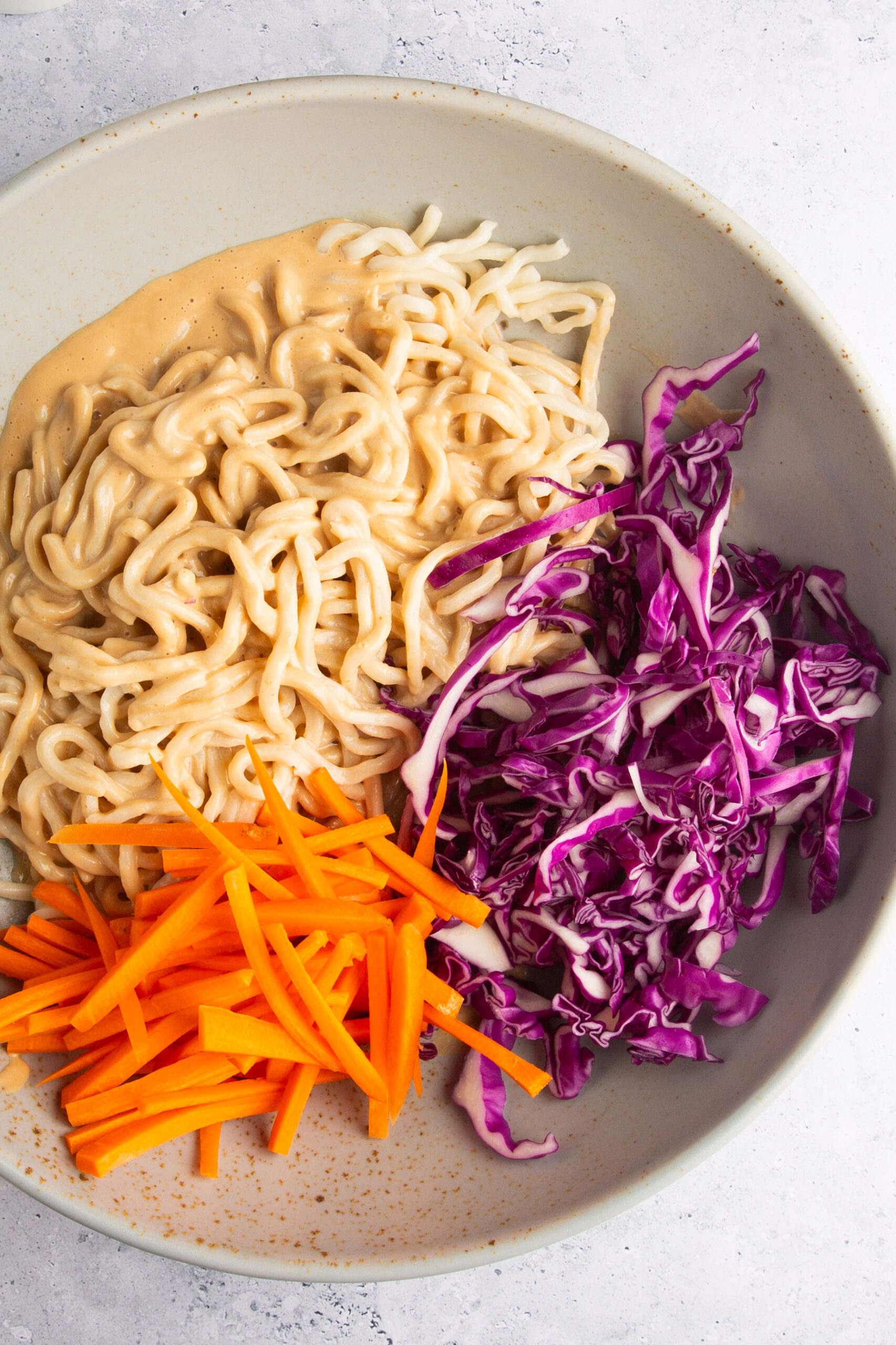 noodles carrots and red cabbage in a bowl