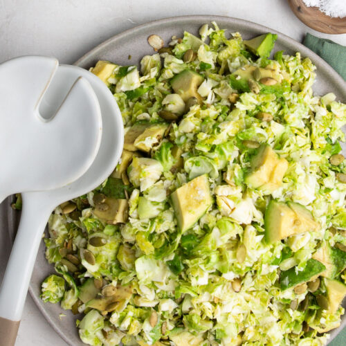 Brussels sprouts salad with avocado and salt.