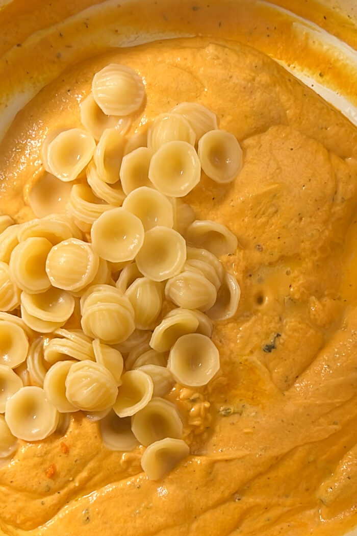 Creamy vegan pumpkin pasta in a white bowl.