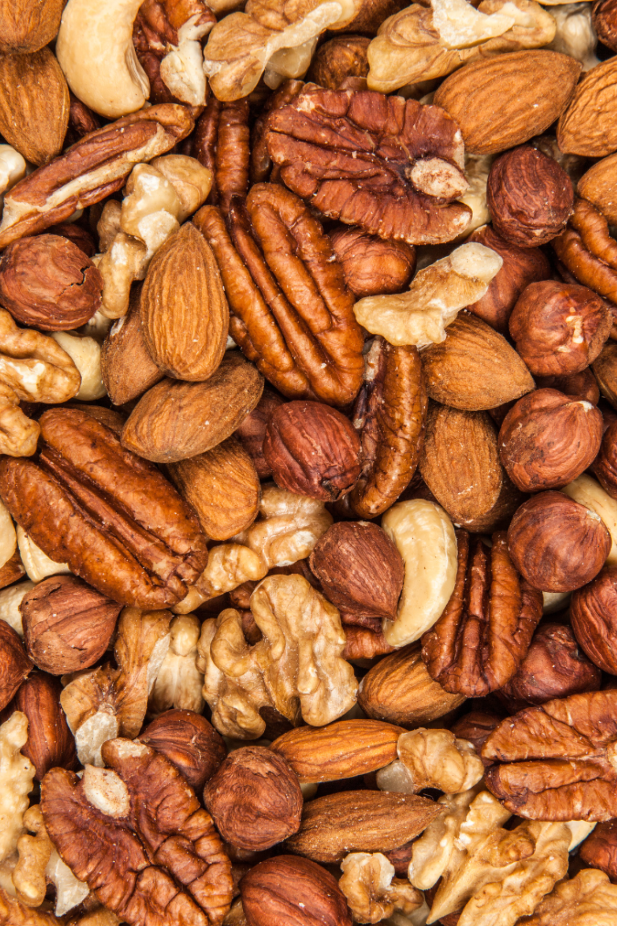 A close up image of a pile of nuts, a plant-based protein.