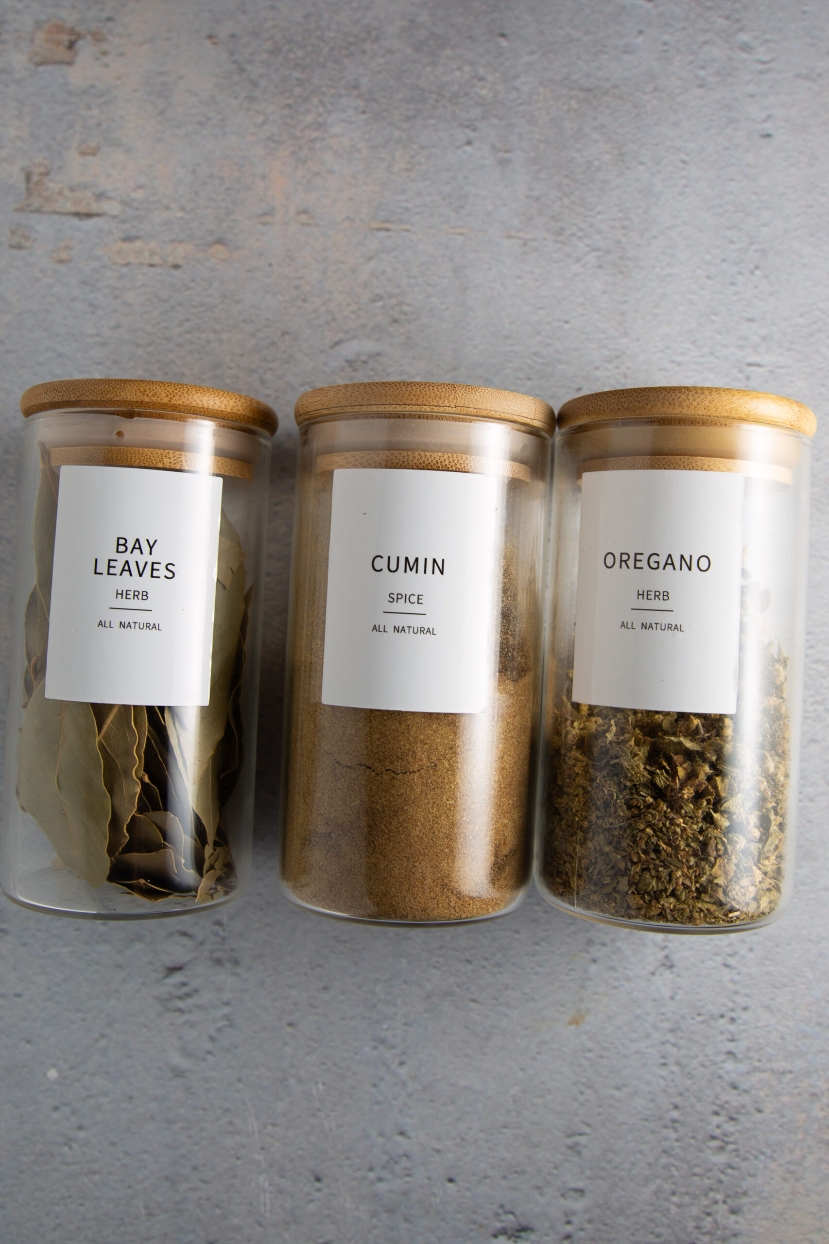 Three jars of spices with lids on them, containing Colorado chile.