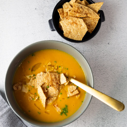 An easy recipe for Butternut Squash Soup with tortilla chips next to it.