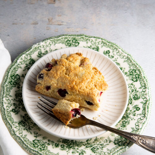 A piece of cranberry scones on a plate.