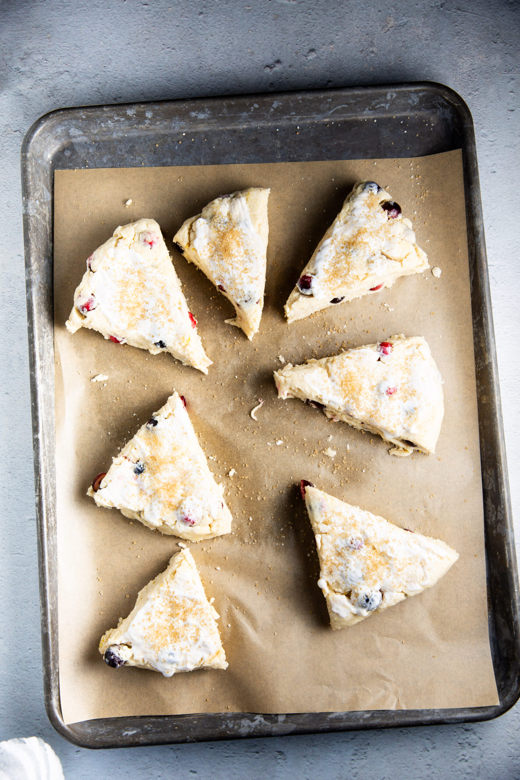 Vegan cranberry scones on a baking sheet.