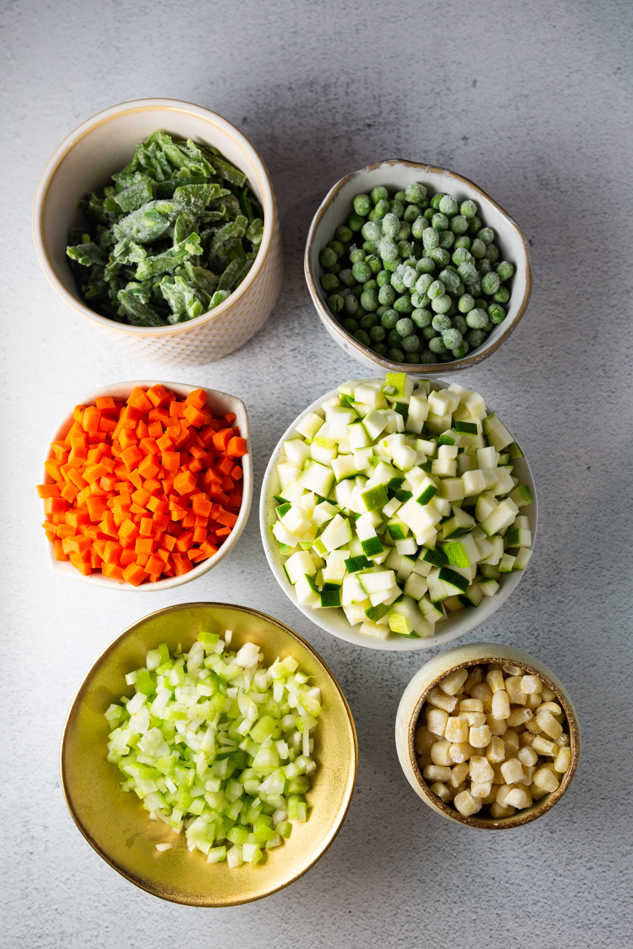 A variety of healthy vegetables in bowls on a table.