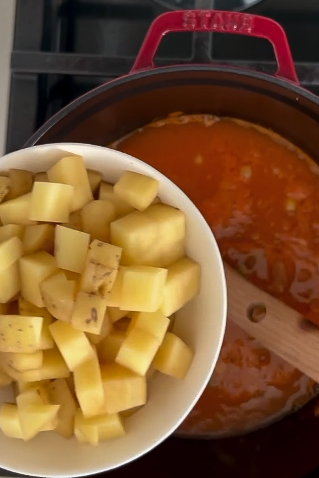 An easy and healthy Sopa De Verduras simmering on the stove, filled with potatoes and sauce.