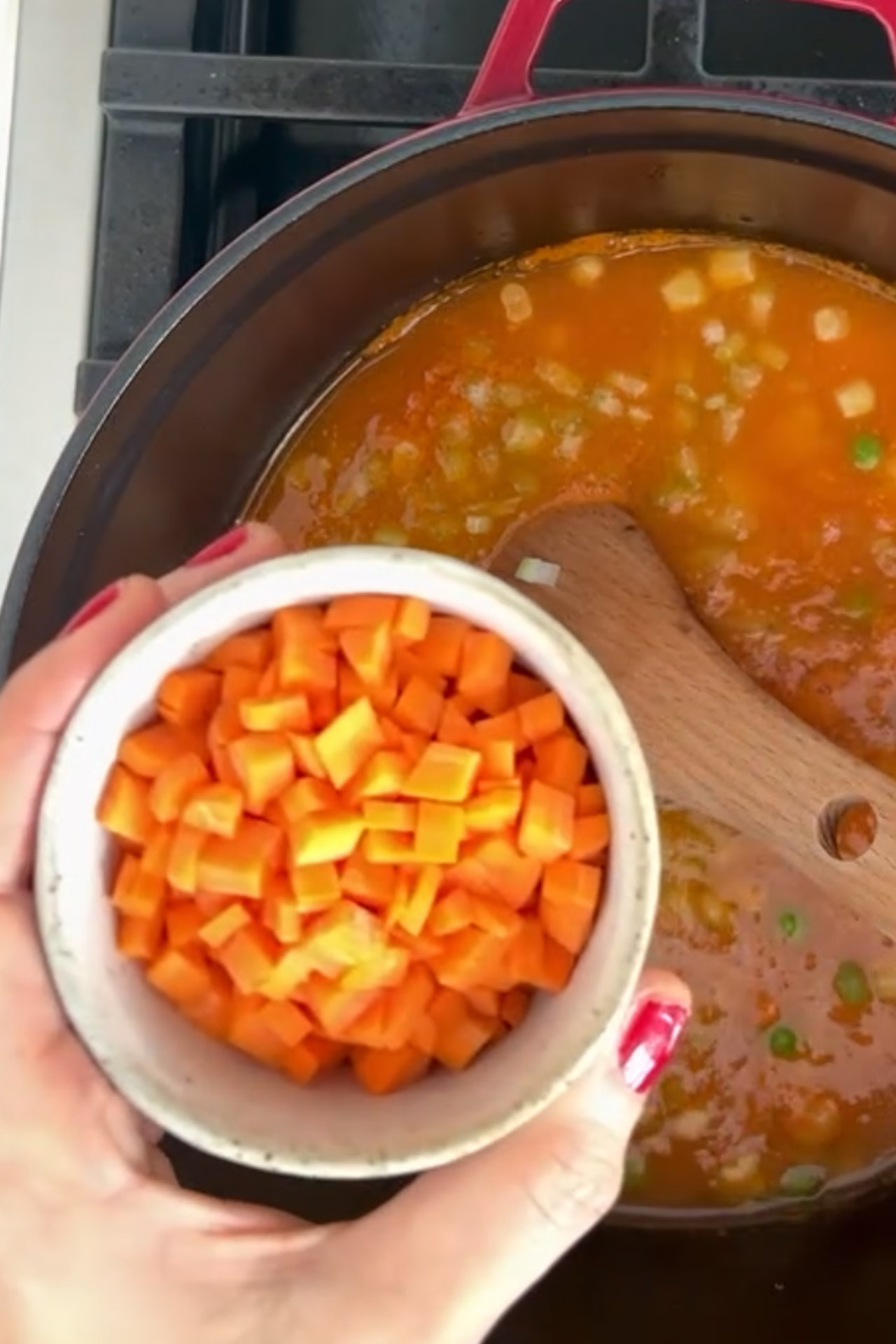 A healthy and easy-to-make Sopa De Verduras with carrots and peas.