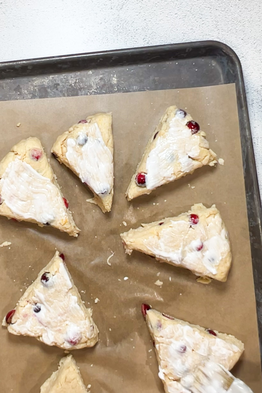 Vegan cranberry scones on a baking sheet.