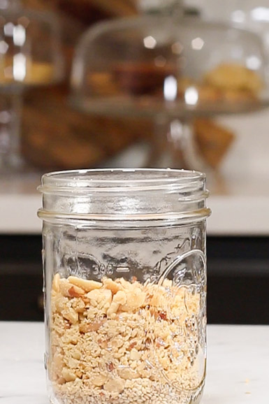 An easy recipe for peanut salsa macha, served in a jar and sitting on a counter.