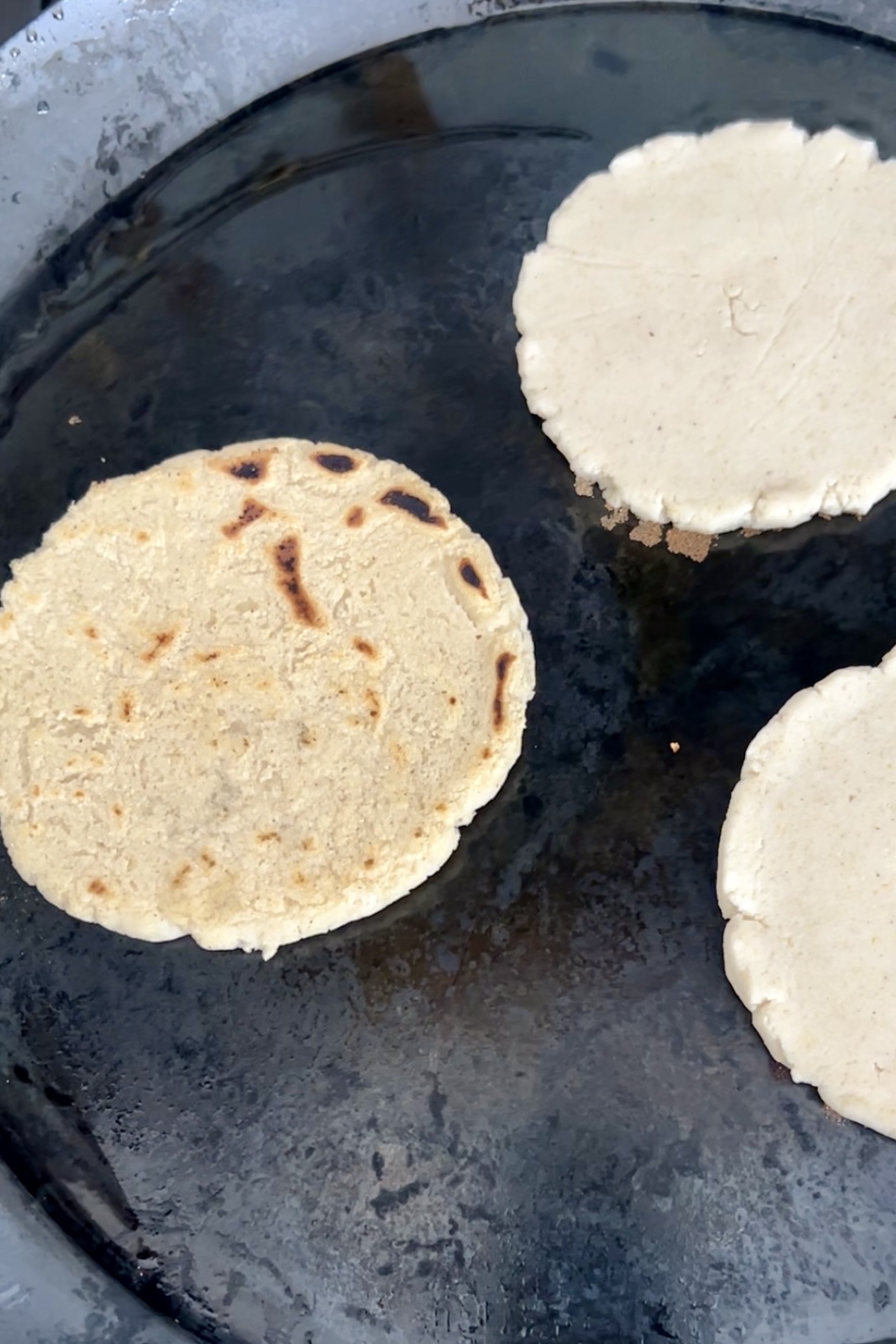 cooking sopes on a comal