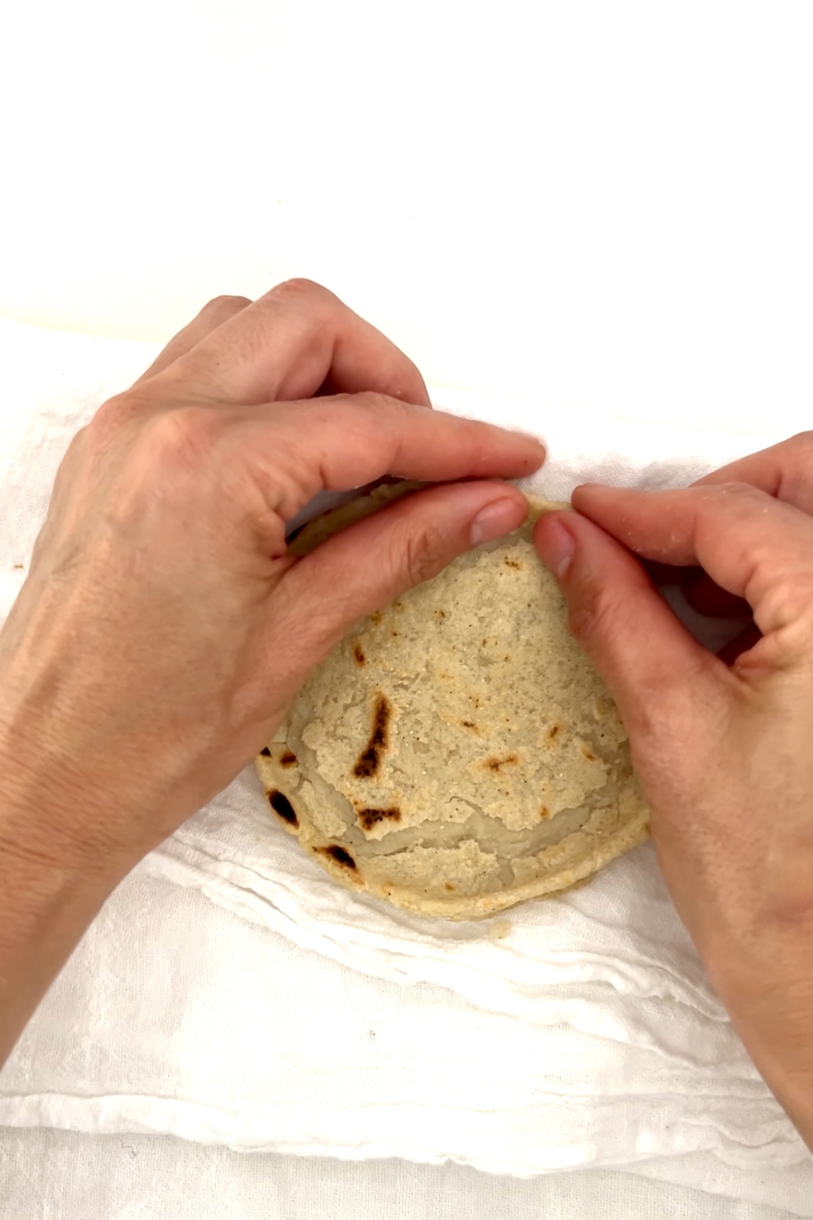 pinching  the sope borderover a white kitchen towel